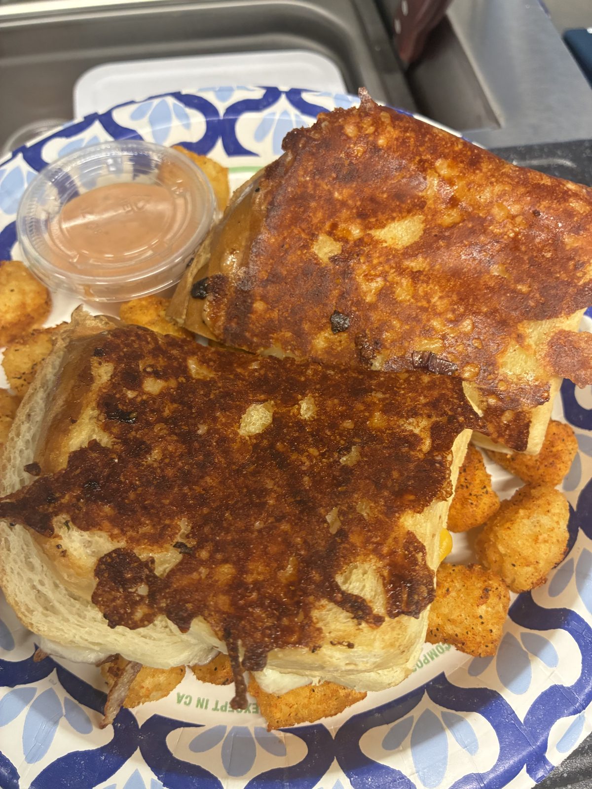 Patty melt with tots and dipping sauce