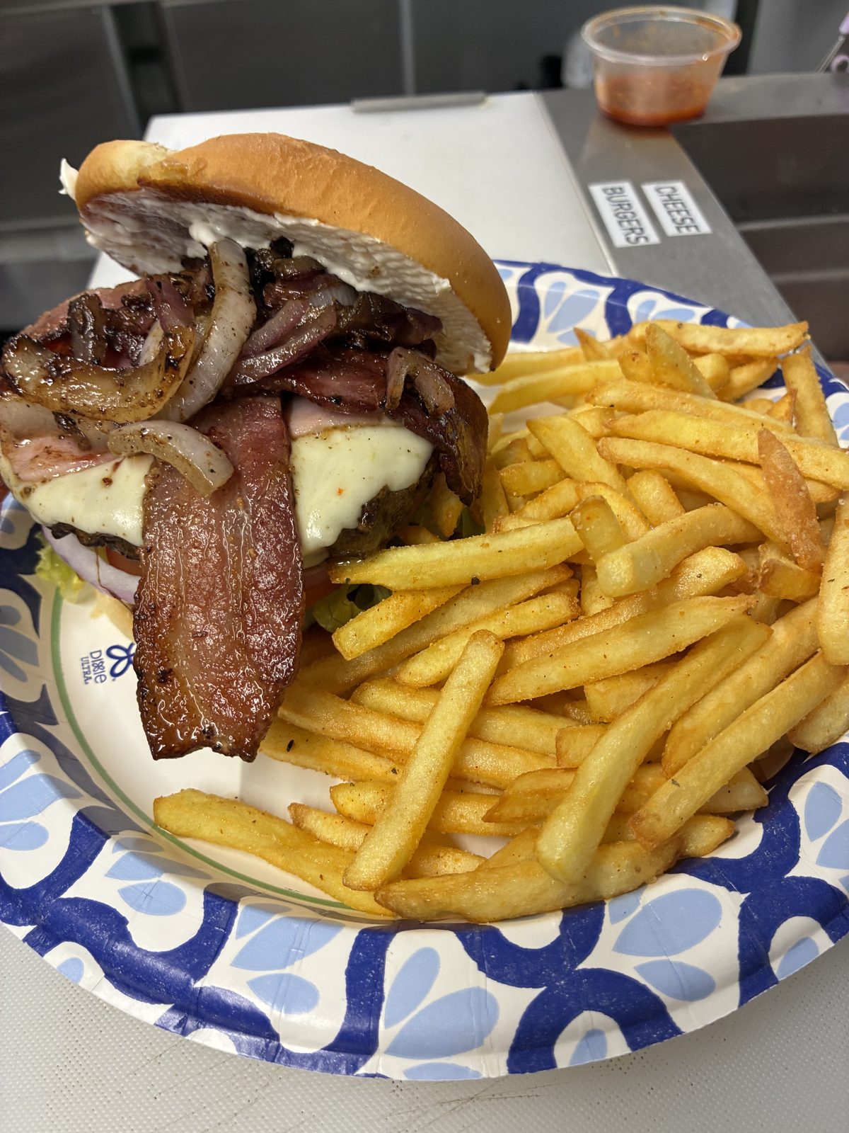 Steak sandwich with grilled onions and fries