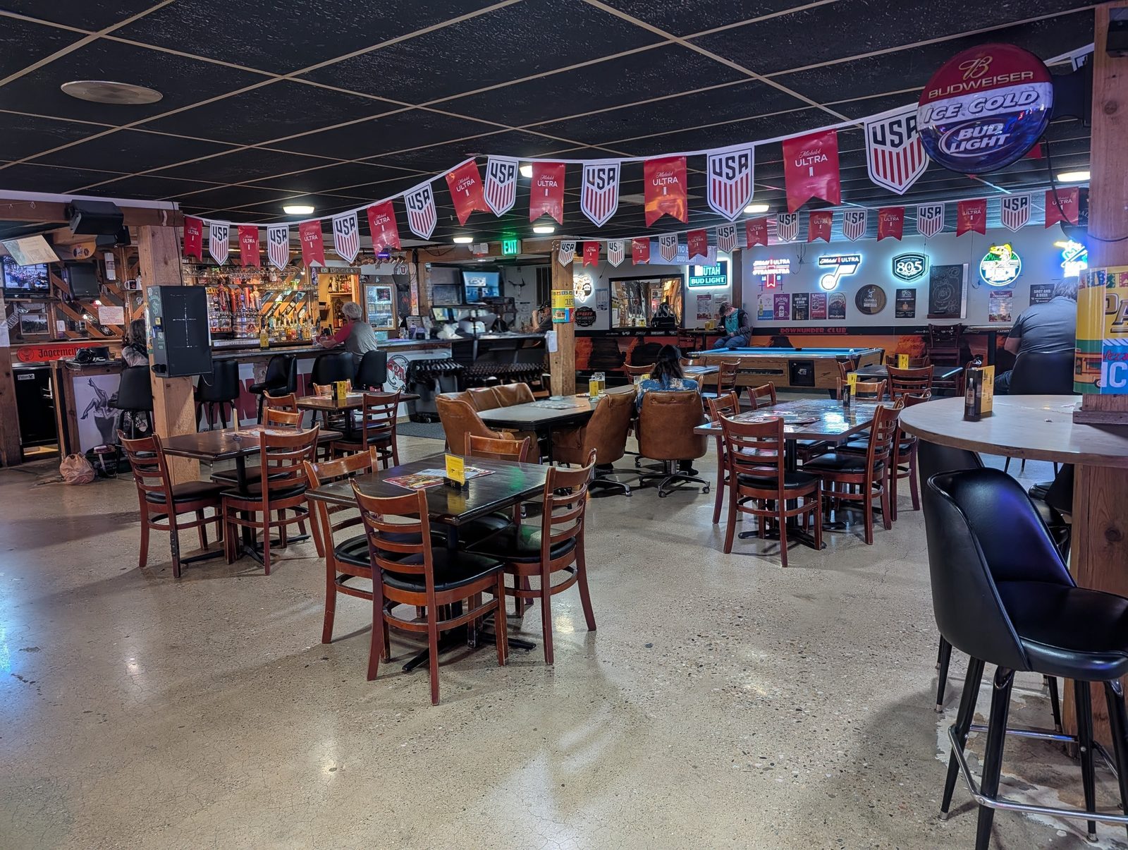 Dining tables under team banners at Down Under