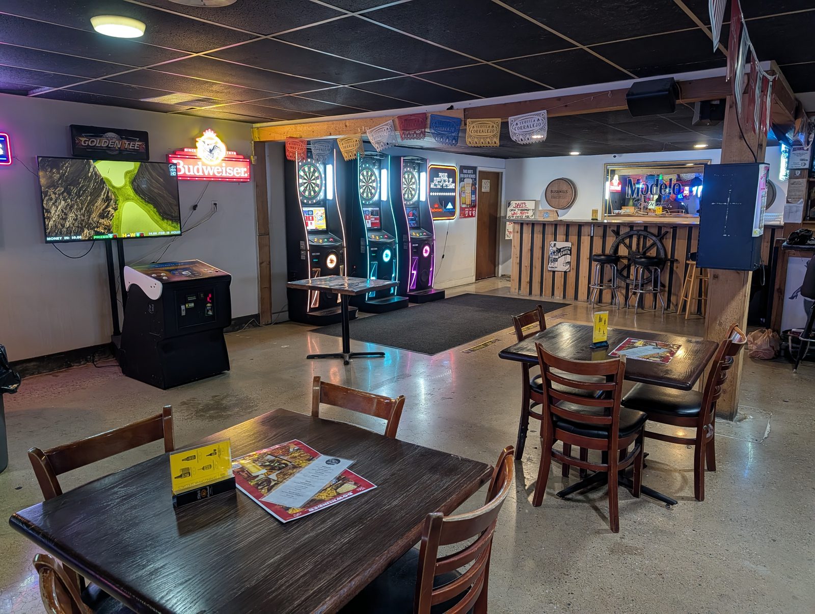 Dartboards and golf arcade game at Down Under