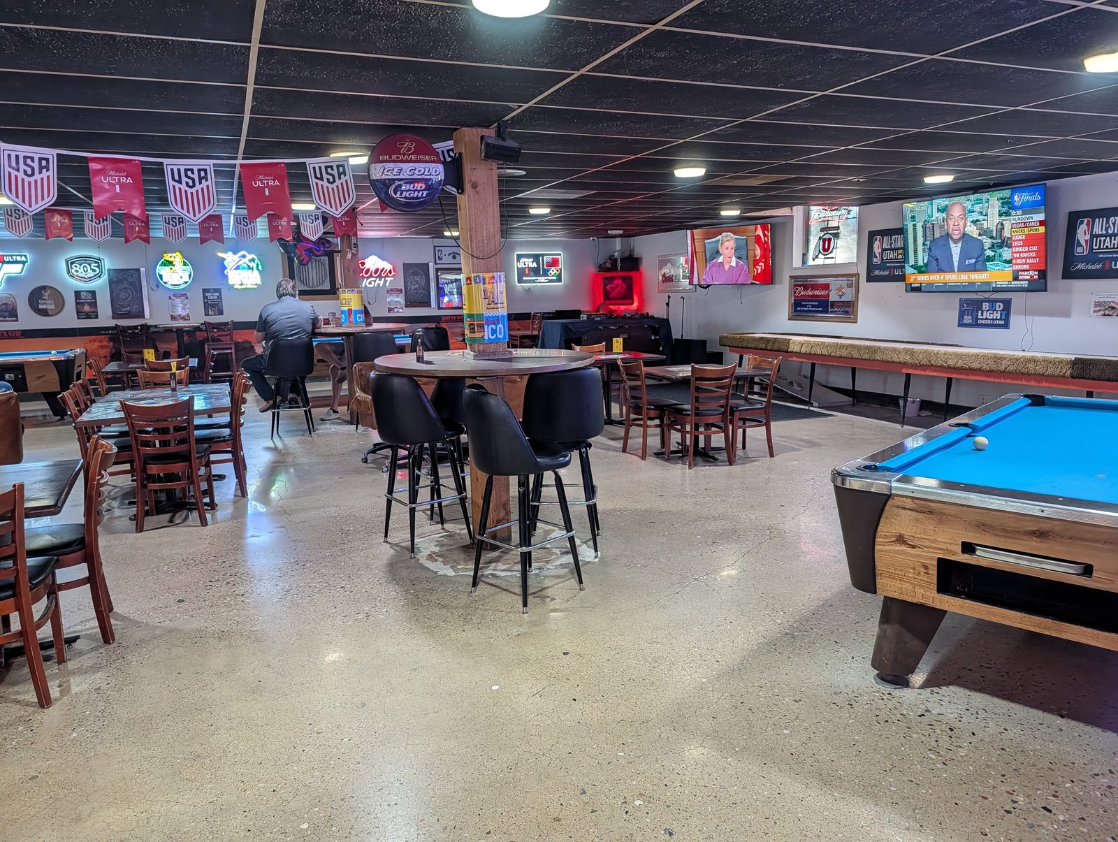 Big screen TVs over the tables, pool, and shuffleboard