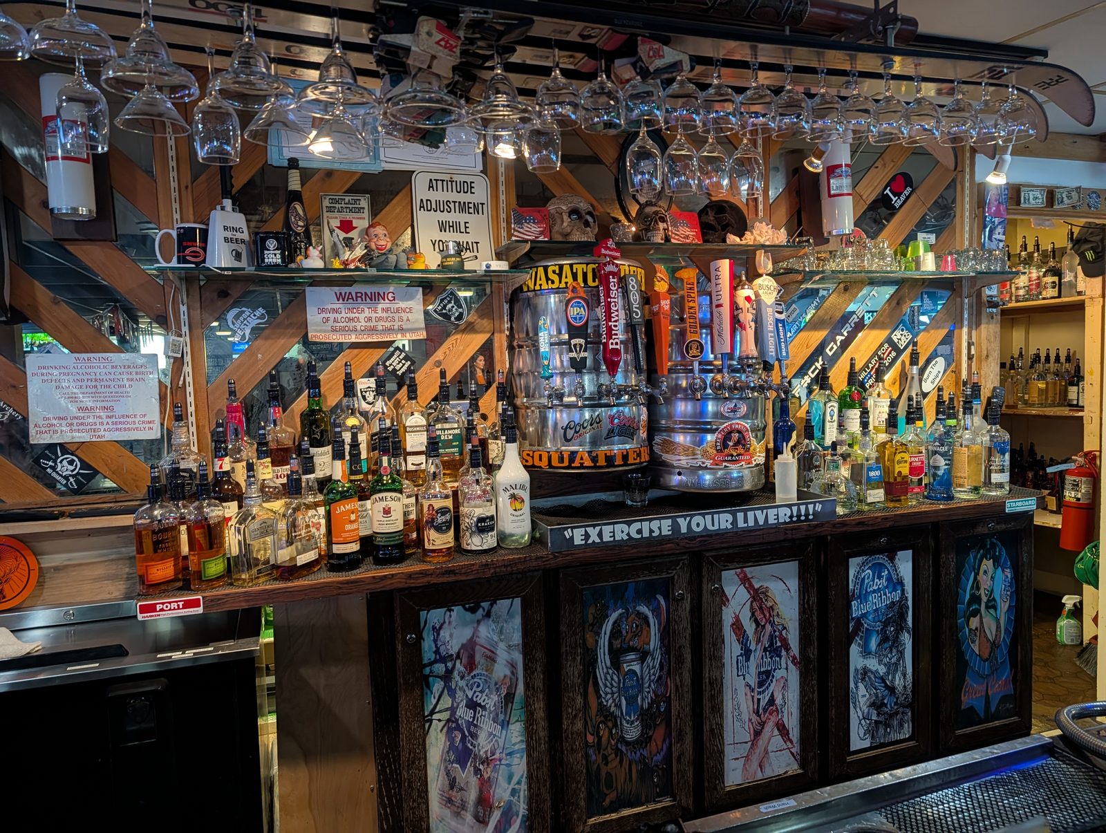 Tap handles, kegs, and the bottle wall at Down Under