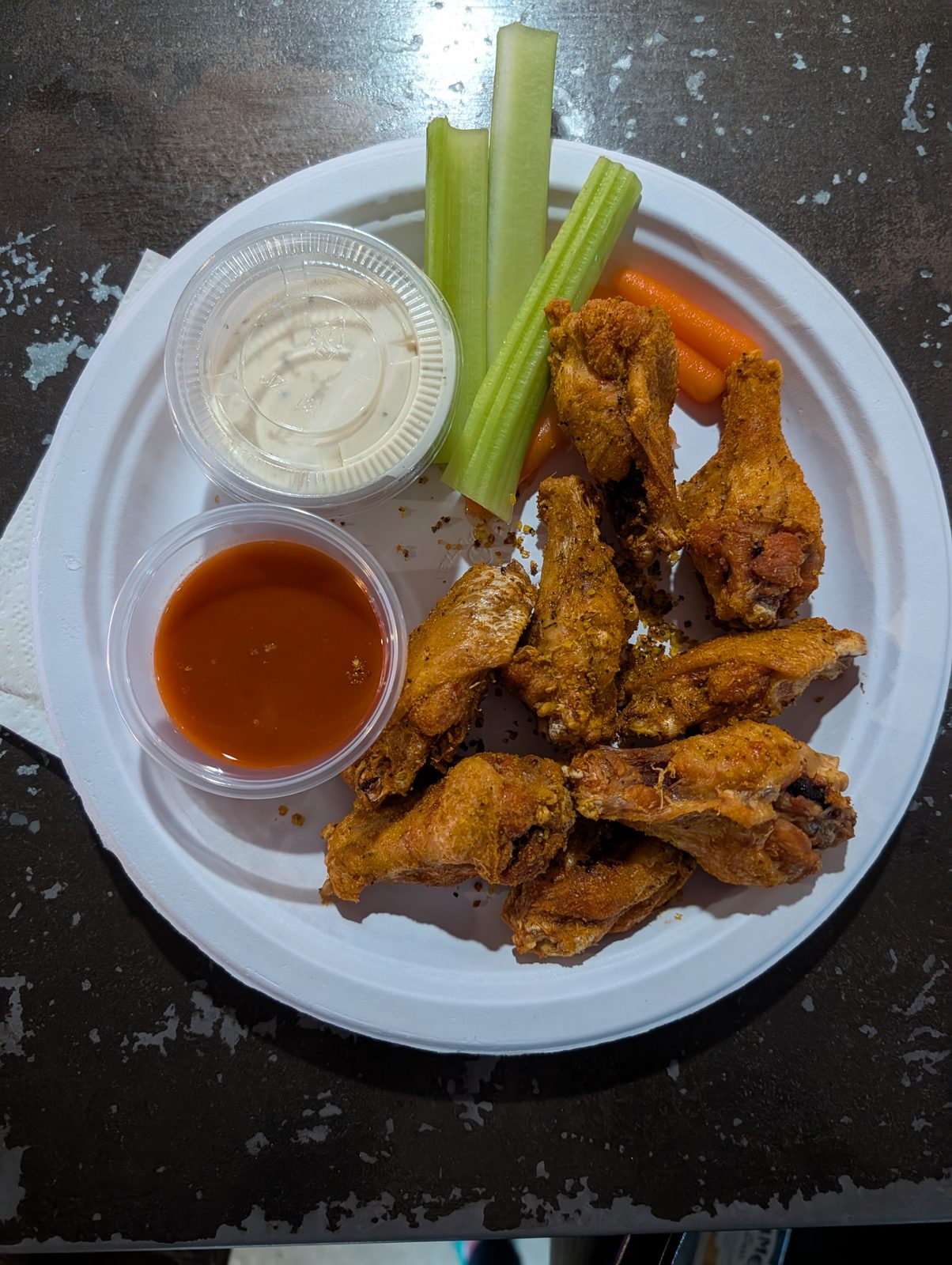 Plate of chicken wings with celery and carrots